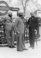 A group of Sikh men outside the entrance to the Hyde Park Corner Underground station (1935).