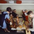 Air hostess and steward serving food on a Scandinavian Airlines flight in 1969.