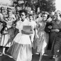 Elizabeth Eckford, age 15, walks into school in Little Rock, Arkansas while a crowd behind her yells “Lynch her”. 1957