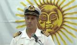 This sun giving a shoulder rub to this navy officer.