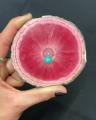 Rhodochrosite with a symmetrical pink stalactite slice and a single eye in the center