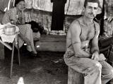An unemployed Oregon lumber worker with his wife - note the Social Security number tattooed on his arm. (1939)