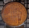 Manhole covers in Oklahoma City sometimes have a map of the local area, with a white dot showing where you are.