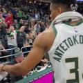 Giannis Antetokounmpo giving away his game shoes to a fan