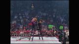 Chris Jericho, after getting chokeslammed, subtlety moves to hold the ladder steady for Kane to win