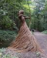 A stunning forest sculpture of a huntress made entirely from willow branches