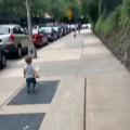 Two toddler besties run towards each other and hug on the street