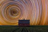 Composite + Long Exposure of Star Trails against a Farmhouse