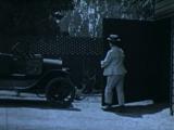 Lloyd Hamilton trying to put his car in the garage in The Simp (1920)