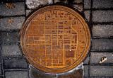 Oklahoma Manhole Covers have a city map on it with a white dot showing where in the city you are