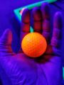 Ultraviolet light, diffusively reflecting off a golf ball, glows pleasantly in my hand.