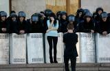 Guy taking photo of his girlfriend with Ukrainian riot police