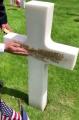 French caretakers take the sand from Omaha Beach and scrub them into the letters to give them the brown/gold coloring.