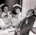 Father faints when he meets his triplet babies for the first time in 1946. This was before ultrasound was invented.