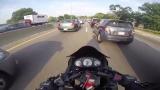 Motorcyclist driving between adjacent rows of vehicle traffic